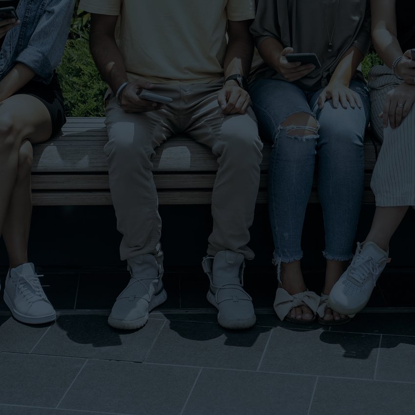 group of people sitting looking at devices