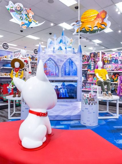 Target bullseye dog looks at Frozen castle and shelves of toys