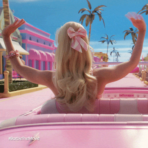 Margot Robbie's Barbie driving her car in Barbieland