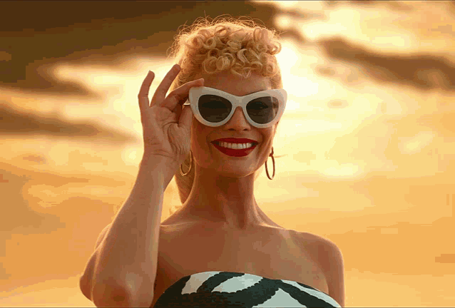 Margot Robbie's Barbie taking sunglasses off and winking