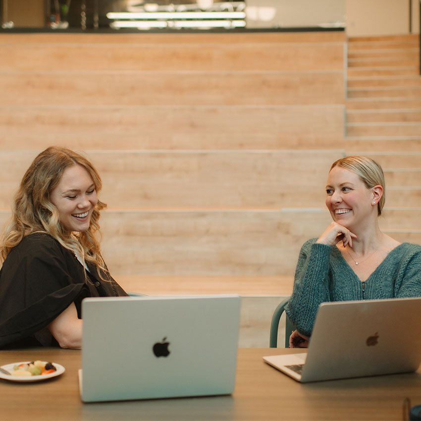 Two Wpromote employees sharing a laugh at work