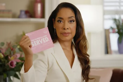 Suits actress poses with a pink paper that read "you've been served"