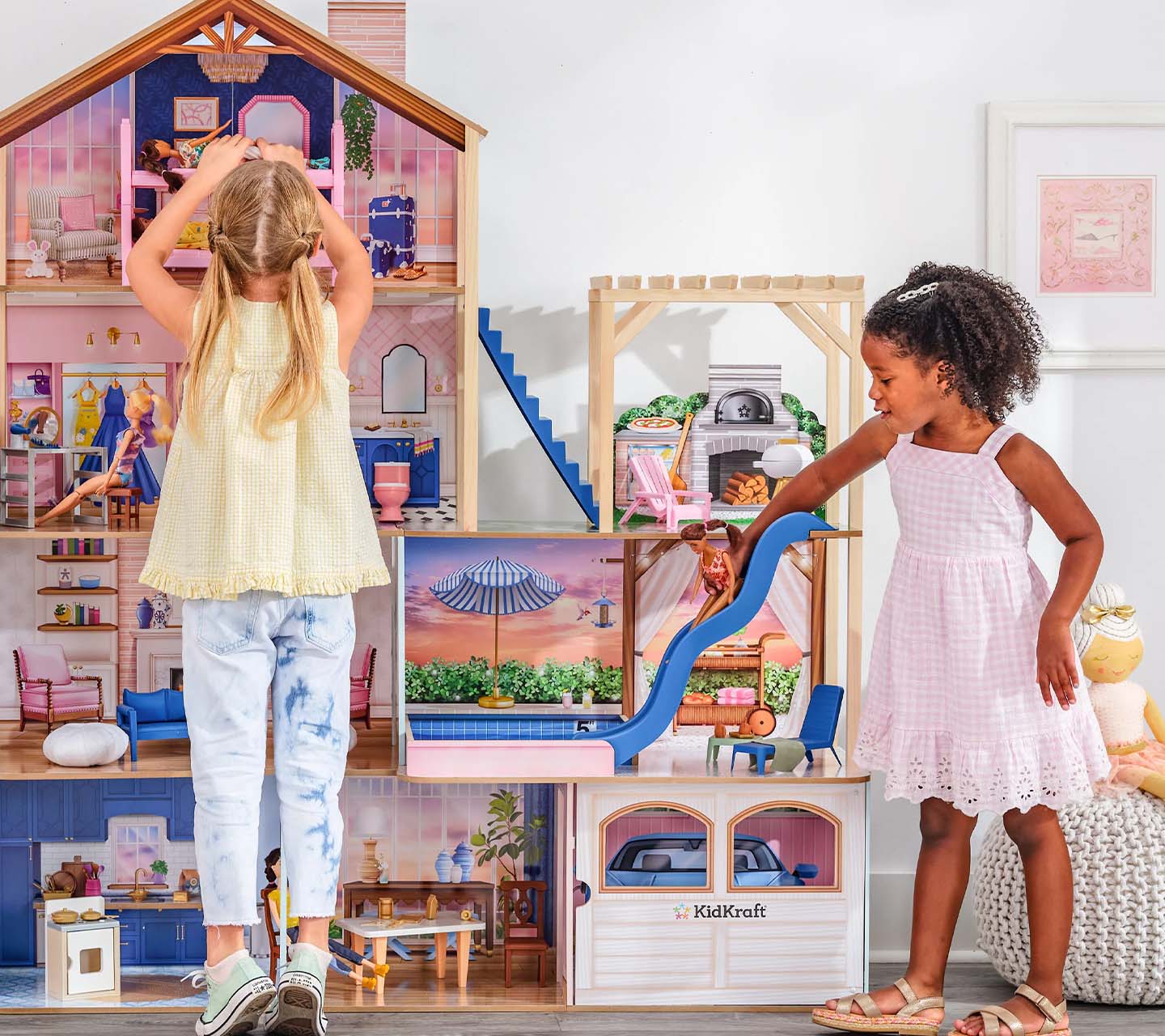 Children playing with KidKraft dollhouse