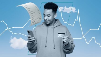 A man looking at a receipt with grocery prices
