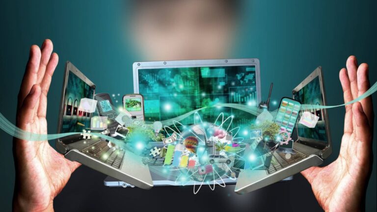 A person holds two open laptops with digital icons and holographic elements emerging, symbolizing technology, innovation, and connectivity.