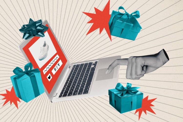 A hand points at a laptop screen displaying an online shopping page with gifts and red stars surrounding the computer.