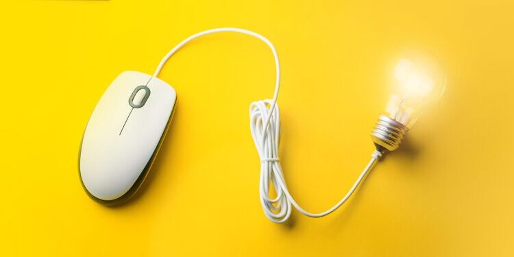 A computer mouse with its cord shaped to connect to a glowing light bulb, all set against a bright yellow background.