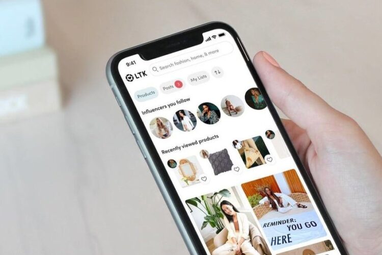 A hand holds a smartphone displaying the LTK shopping app, showing influencer profiles, recently viewed products, and product images.