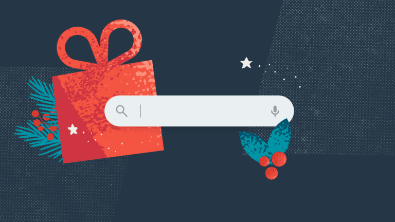A search bar is centered on a dark background with a red gift box, green pine branches, and holly next to it, suggesting a holiday or festive theme.