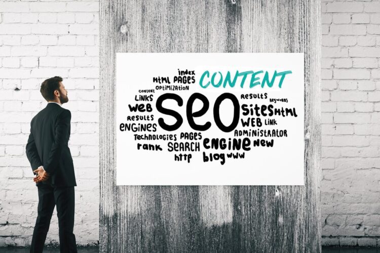 A man in a suit looks at a word cloud on a whiteboard related to SEO concepts, including words like "content," "web," "search," "engine," and "optimization.