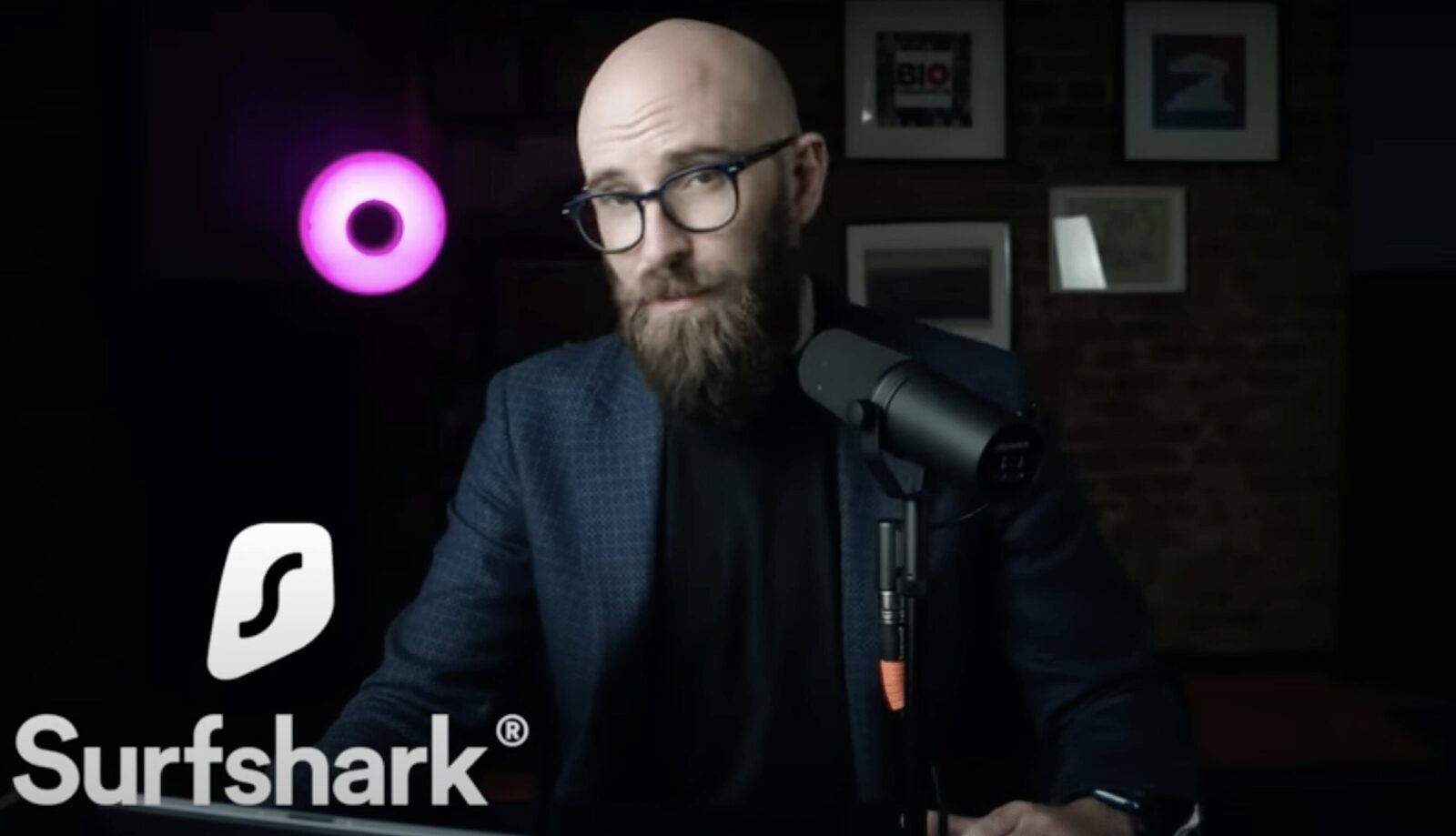 Bald man talking into microphone