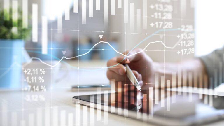 Person using a stylus on a tablet with superimposed financial graphs, charts, and percentage figures, indicating data analysis or stock market activity.