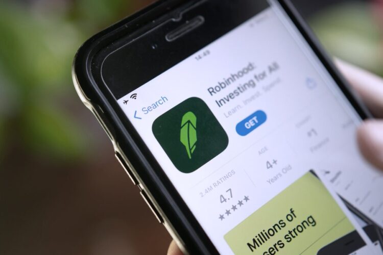 A smartphone screen displays the Robinhood app on the App Store, showing its icon, ratings, and the option to download.