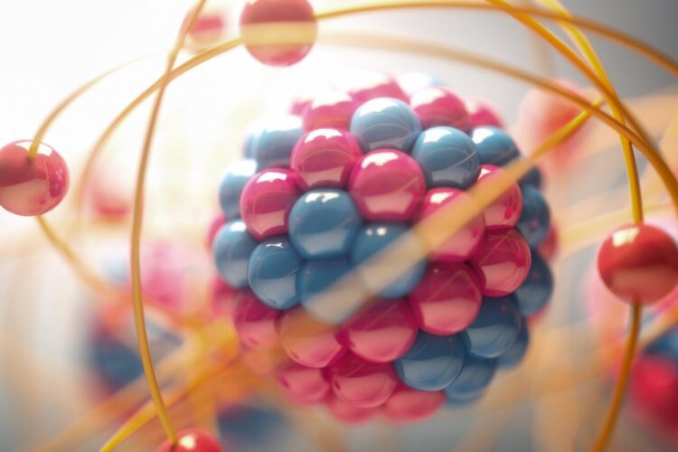 A colorful illustration of an atom, showing a nucleus made of blue and pink spheres surrounded by orange orbiting particles.