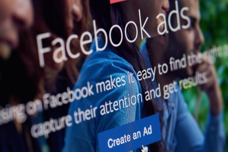 A computer screen displays the Facebook Ads interface, with a highlighted "Create an Ad" button and text promoting ad benefits.