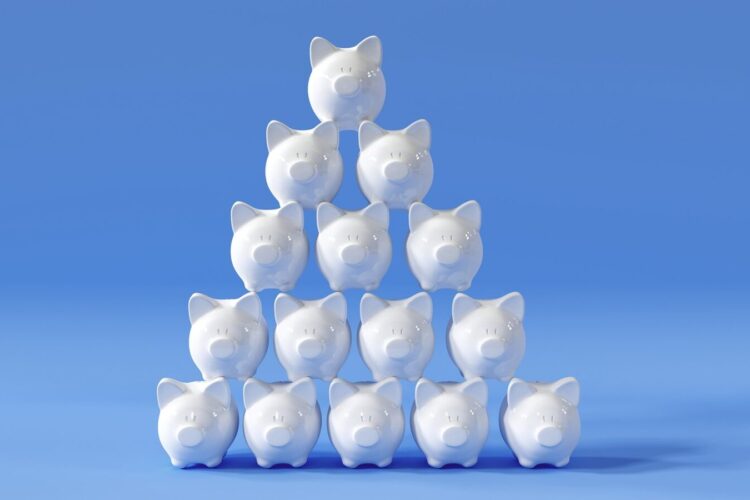 A pyramid of white piggy banks is stacked against a solid light blue background.