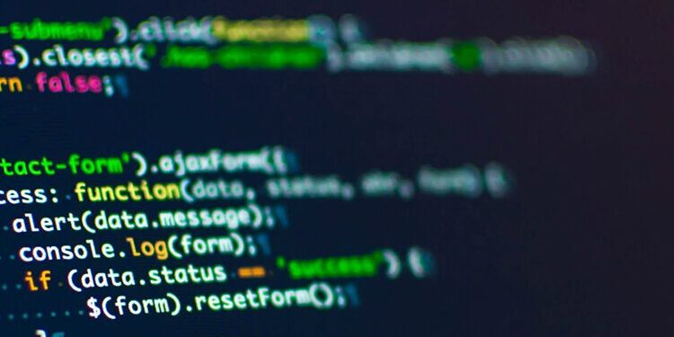 A computer screen displays lines of JavaScript code, including functions for handling a contact form and displaying alerts.