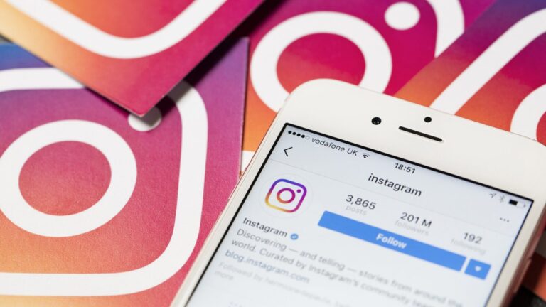 A smartphone displays the Instagram profile page, with Instagram logo cards in the background.