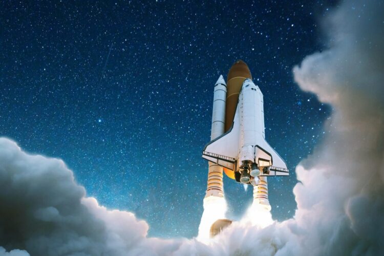 A space shuttle launches into a starry night sky, emitting bright flames and surrounded by clouds of smoke.