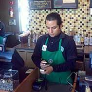 qrcodereciept starbucks employee scanning qr code for loyalty