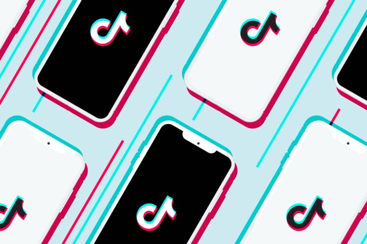 Several smartphones with black and white screens display the TikTok logo, arranged diagonally on a light blue background.