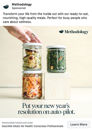 A hand stacks glass jars filled with prepared meals, featuring vegetables and greens, on a light wooden surface. Text promotes healthy, ready-to-eat meals for wellness and convenience.
