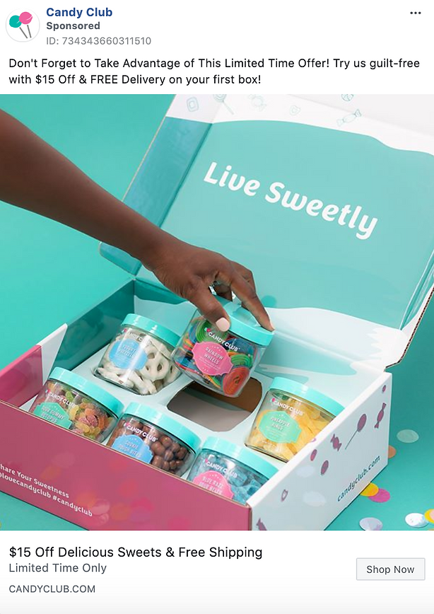 A person’s hand selects a candy jar from an open Candy Club subscription box filled with assorted colorful sweets. Text on the box reads "Live Sweetly.