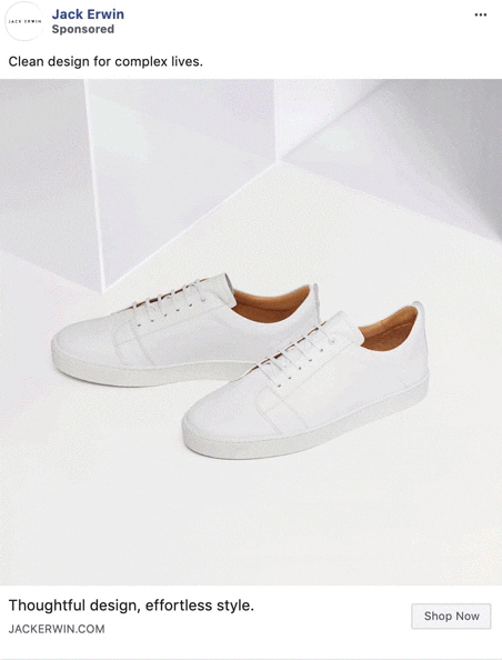 A pair of minimalist white sneakers with brown inner lining are displayed on a white geometric surface.