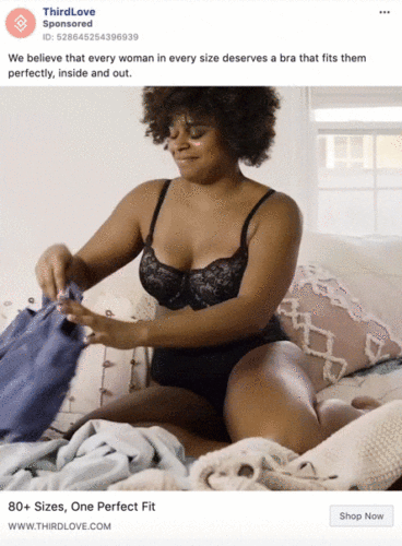 A woman wearing a black bra and underwear sits on a bed folding laundry. Text: "80+ Sizes, One Perfect Fit. Shop Now.