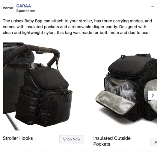 A black baby bag attached to a stroller with hooks, showing insulated outside pockets and a removable diaper caddy.