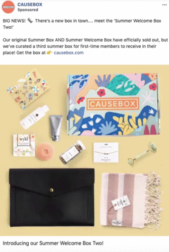 A flat lay of the CAUSEBOX Summer Welcome Box Two, featuring skincare products, a journal, a striped towel, a black clutch, and a colorful box with the CAUSEBOX logo.