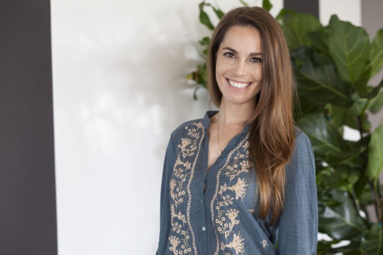 A woman smiling at camera.