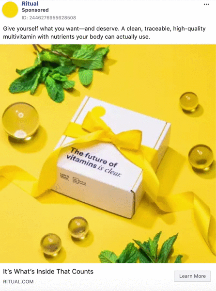 A white box labeled "The future of vitamins is clear" with a yellow ribbon sits on a yellow surface, surrounded by mint leaves and clear spheres.
