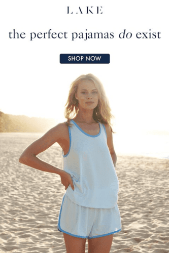 A woman wearing light blue pajamas stands on a sandy beach at sunset under text that reads, "the perfect pajamas do exist.