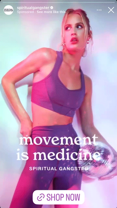 A woman in athletic wear holds a disco ball under one arm. Text on the image reads: “movement is medicine. SPIRITUAL GANGSTER.” A “SHOP NOW” button is at the bottom.