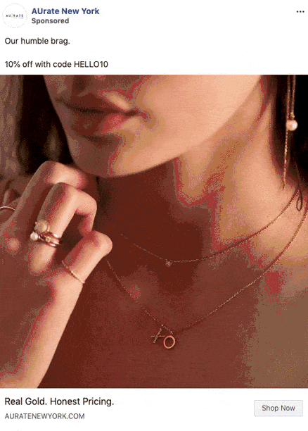 Close-up of a woman wearing gold jewelry, including hoop earrings, layered necklaces, and rings. Text overlay offers 10% off with code HELLO10 from AUrate New York.