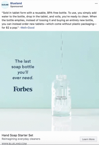 A clear bottle labeled "BLUELAND" is being filled with water. Text on the wall reads: "The last soap bottle you'll ever need. Forbes.