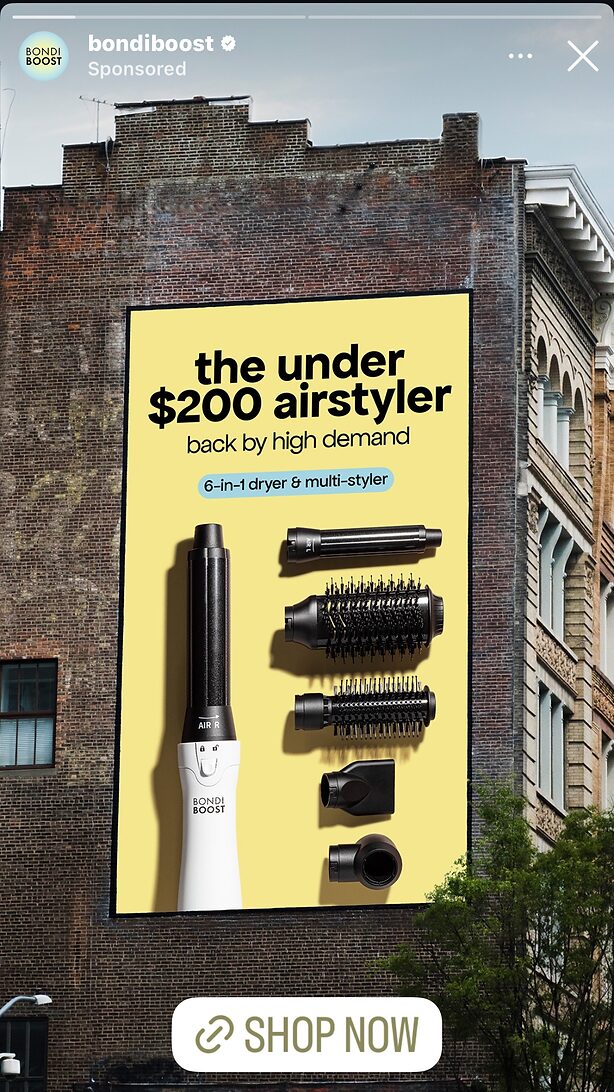 A large billboard on a brick building advertises the BondiBoost Airstyler, featuring six styling attachments and text highlighting its price under $200.