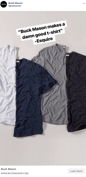 Four short-sleeve t-shirts in white, navy, gray, and charcoal are laid flat on a light surface. Text above reads: "'Buck Mason makes a damn good t-shirt' - Esquire.