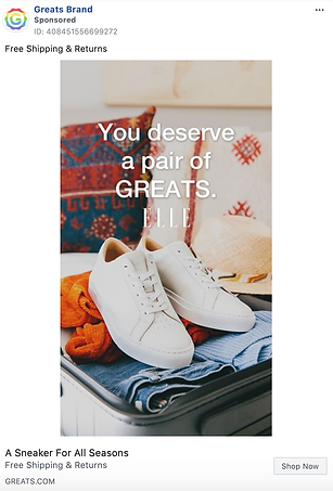 A pair of white sneakers is placed on top of clothes inside an open suitcase, with the text "You deserve a pair of GREATS." written over the image.