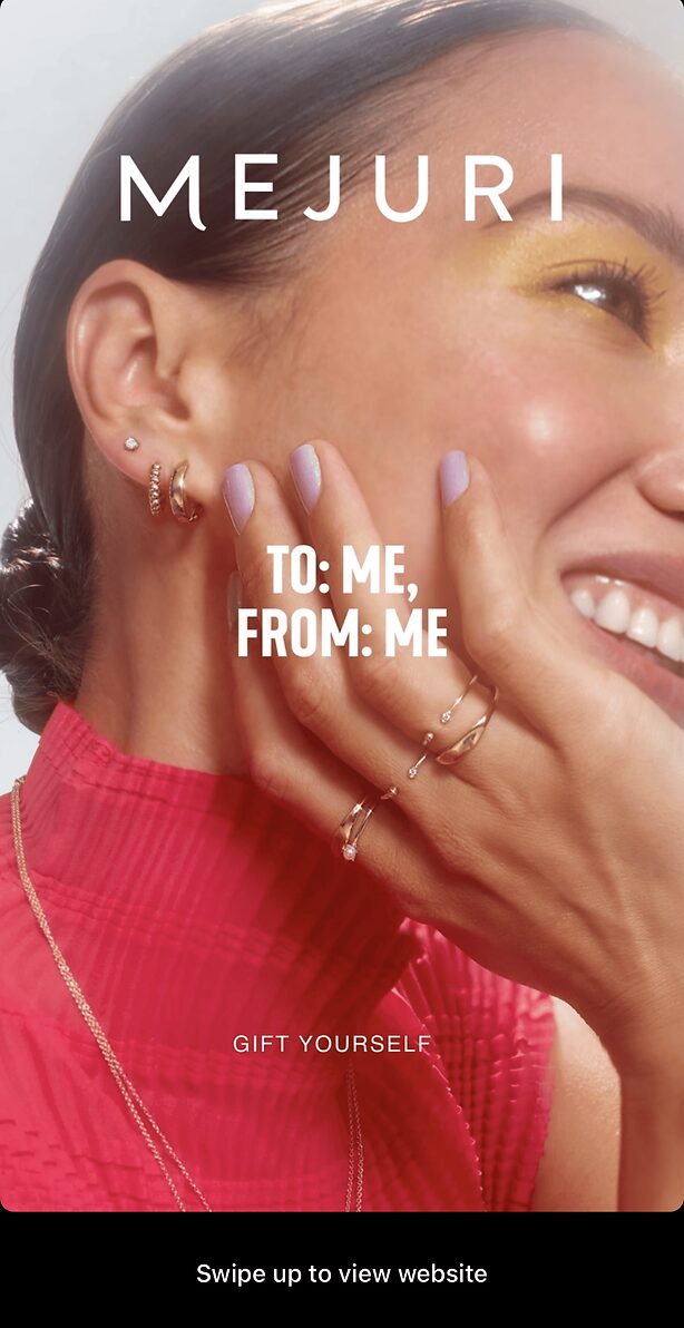 A woman wearing gold jewelry and a red top smiles, showing purple nails and multiple rings. Text on image reads, "TO: ME, FROM: ME. GIFT YOURSELF. MEJURI.