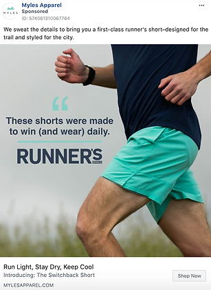 A person runs outdoors wearing teal and navy athletic shorts and a navy shirt. Text on image reads: "These shorts were made to win (and wear) daily. RUNNER'S.