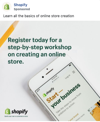 A phone displays the Shopify login page next to a notepad and pencil. Text above reads, "Register today for a step-by-step workshop on creating an online store.
