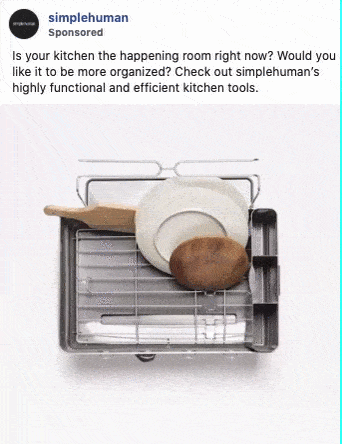 A dish drying rack holds a pan, plate, and cutting board; water pours off the rack, highlighting its drainage function.
