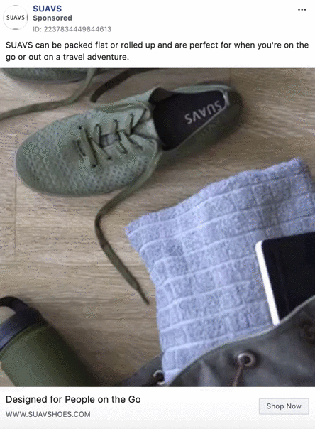 A pair of SUAVS green shoes, a gray textured pouch, and a partially visible laptop are arranged on a flat surface next to a green jacket.