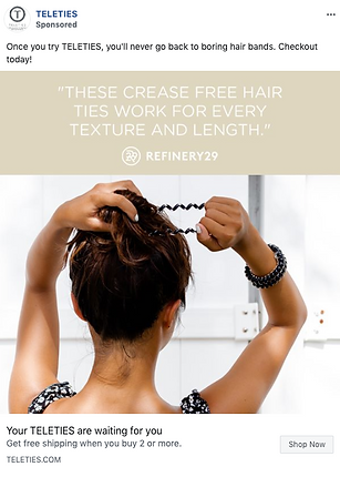 A woman with brown hair ties her hair with a black spiral hair tie, facing away from the camera; text overlay promotes TELETIES hair ties.