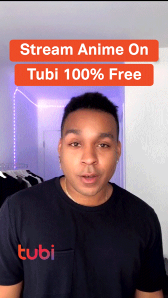 A person stands indoors with text above stating "Stream Anime On Tubi 100% Free" and a Tubi logo on the shirt.