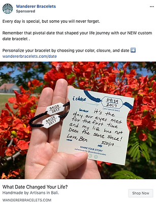 A hand holds a black bracelet with a custom date tag and a note recalling a meaningful date, set against a background of red flowers.