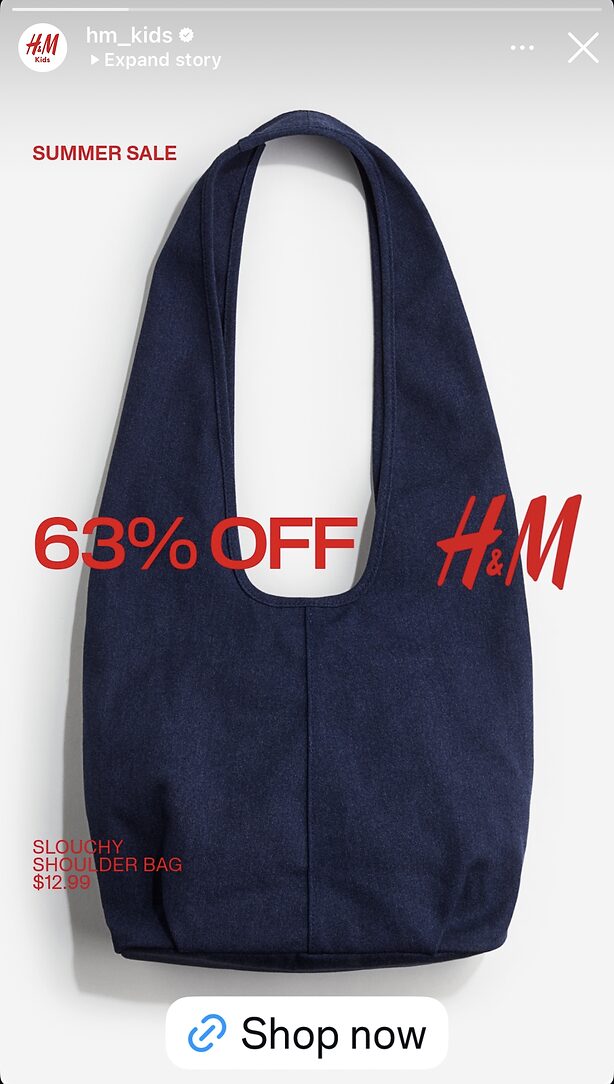 A navy blue slouchy shoulder bag is displayed on a white background with red text advertising 63% off and a $12.99 price for a summer sale at H&M.