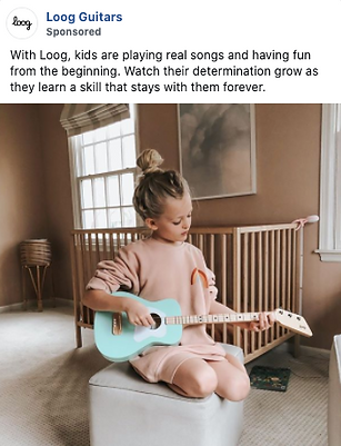 A young girl sits on a bed playing a small light blue guitar in a cozy, softly lit bedroom with neutral decor.